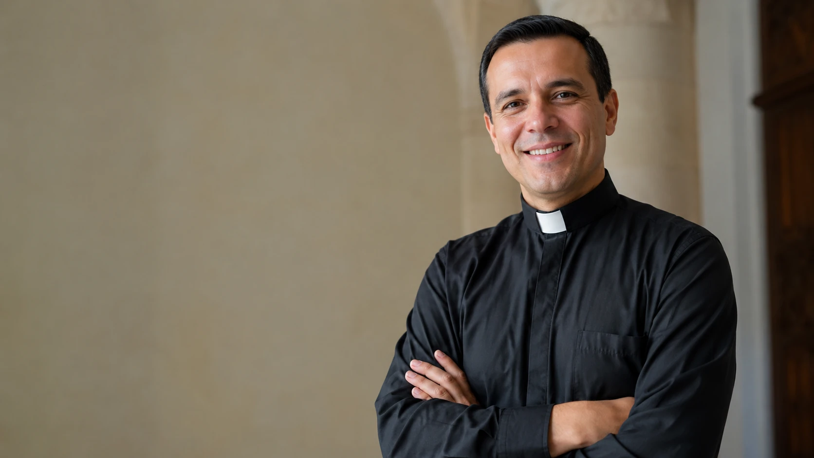 A priest smiling in a church cloister